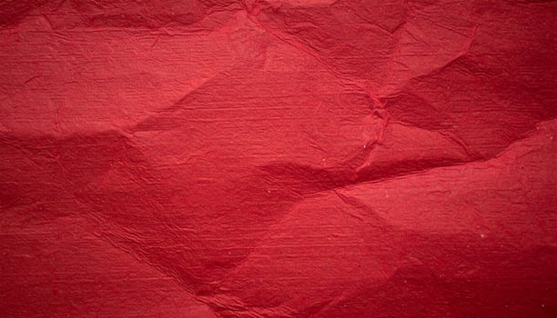 Close-up background of deep crimson paper with a textured pattern, ideal for presentation slides photo