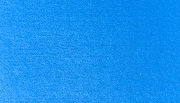 Close-up of vibrant electric blue paper with textured pattern background photo