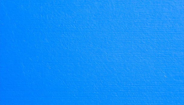 Close-up of a vibrant electric blue paper with textured pattern as the background photo