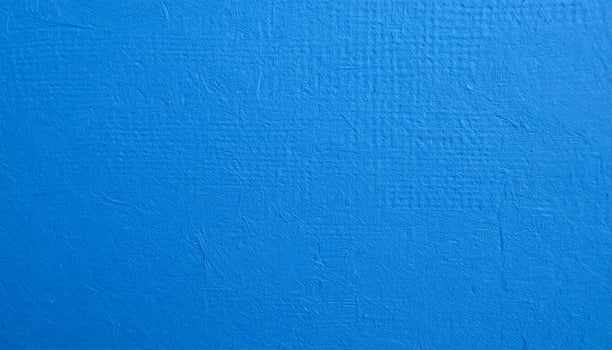Close-up of a vibrant blue paper with textured pattern as the background. photo