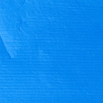 Close-up of a vibrant electric blue paper background with textured patterns photo