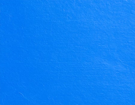 Close-up of a vibrant electric blue paper texture with a subtle pattern as the background photo