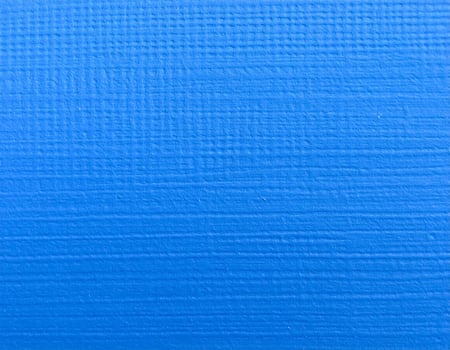 Close-up of a vibrant blue paper with electric hues and textured pattern as the background photo