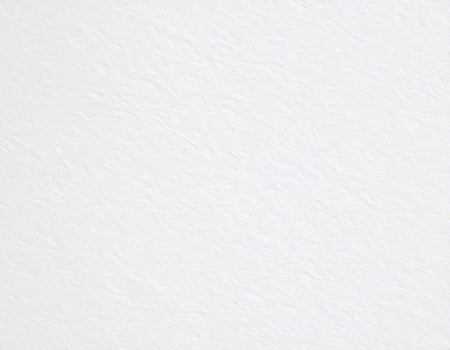 Close-up of a white, rugged paper surface with a textured pattern background photo