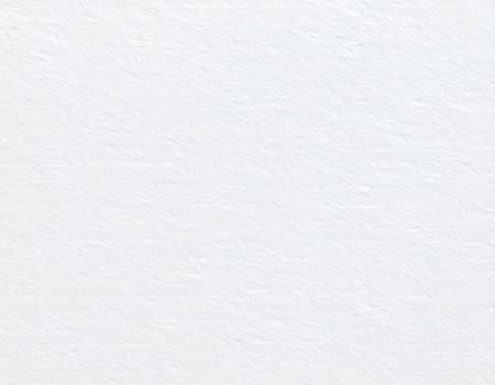 Close-up of a white, coarse paper surface with a textured pattern as the background. photo