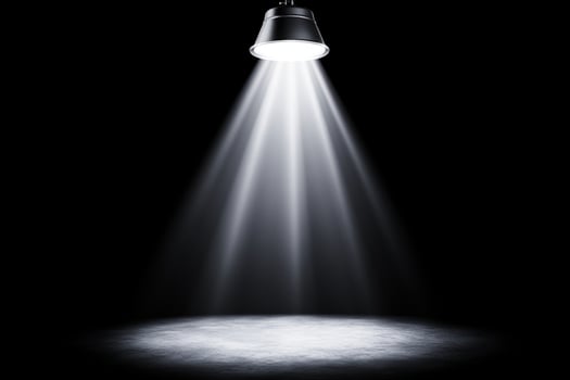 Light shining from a spotlight on a black background photo