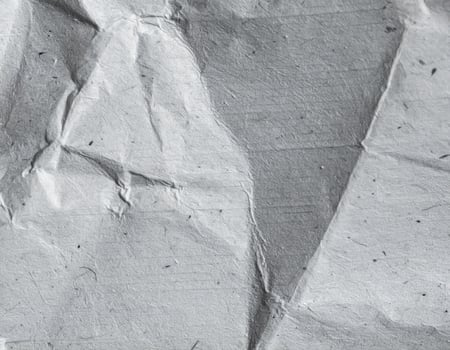 Close-up of a textured gray paper surface with a rough finish and patterned background photo