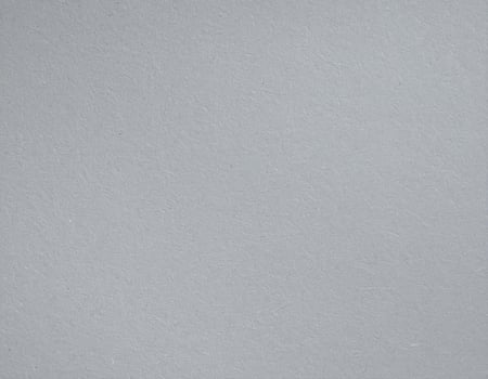 Nearby shot of a coarse gray paper surface with textured pattern. photo