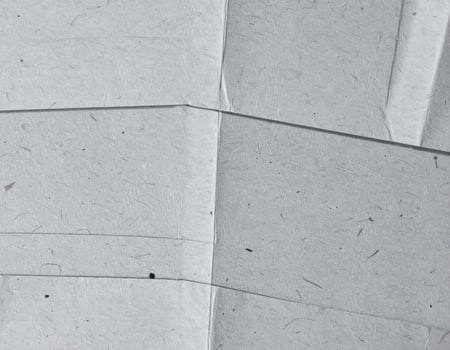 Close-up of a rugged gray paper surface with textured pattern background photo