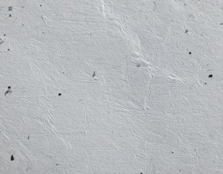 Near-eye view of a coarse, gray paper surface with textured pattern background photo