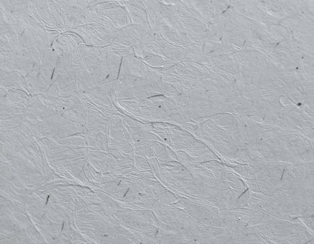 Close-up of a rugged gray paper surface with textured patterns photo