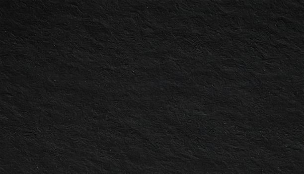Close-up of a dark, coarse-textured paper with a patterned surface. photo