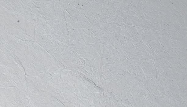 Close-up of a gritty gray paper surface with a textured pattern background photo