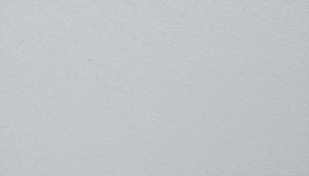 Close-up of a textured gray paper surface with a rough finish. photo