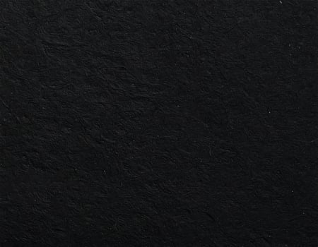 Close-up of a black, coarse paper surface with textured pattern background photo