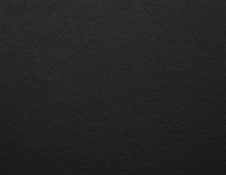 Close-up of a dark, rough paper surface with textured pattern background photo