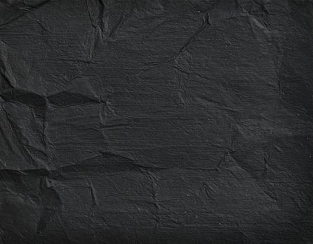 Close-up of a gritty black paper surface with a textured pattern background photo