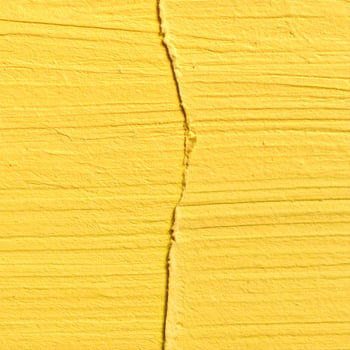 Close-up of a rough yellow paper surface with a textured background photo