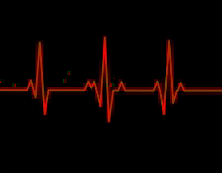 Vibrant heartbeat line in color against a dark background photo