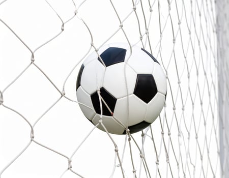 Football striking the net against a white backdrop, capturing a scoring moment photo