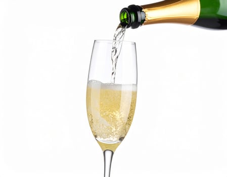 Champagne being poured into a glass against a white backdrop photo