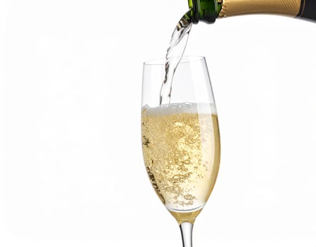 Chilling champagne being poured into a glass against a white backdrop photo