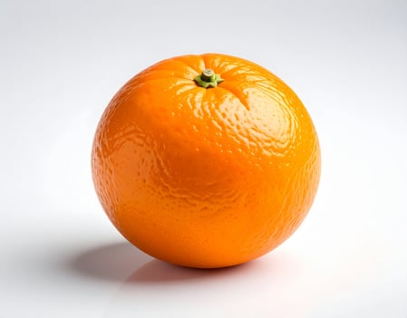 Orange tangerine placed against a plain white backdrop photo
