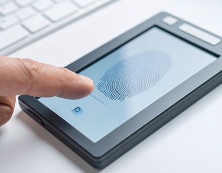 Using a contemporary device to capture fingerprint scans against a plain white backdrop photo