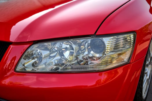 Modern red car front lights close view photo