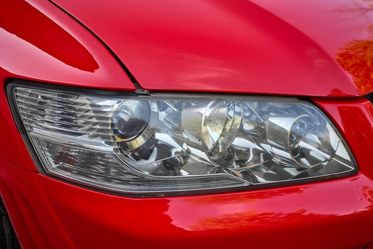 Close-up of the front lights on a contemporary red vehicle photo