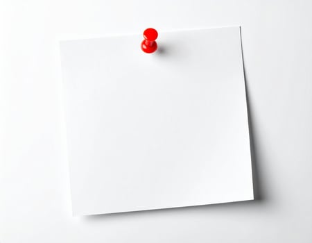 White stationery sheet pinned to a plain white background photo