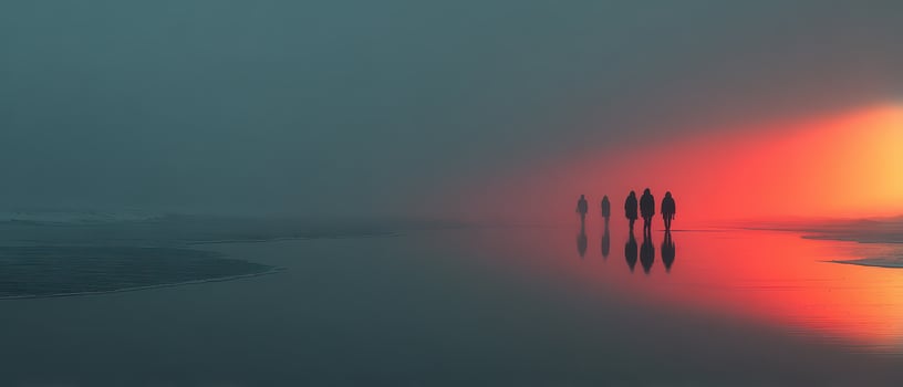 Group walks on foggy beach at sunset photo