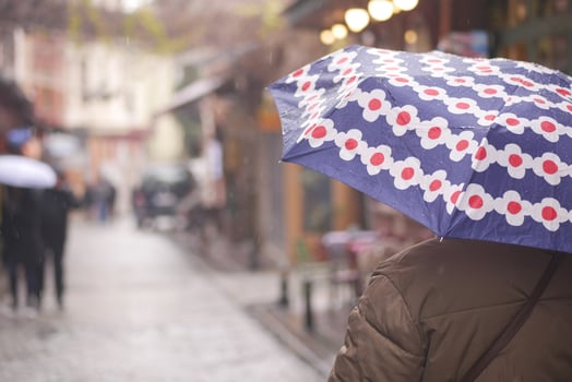 Rainy day walk with colorful umbrella in city street photo