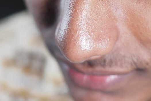 Close-up of a person's nose showcasing detailed skin texture photo