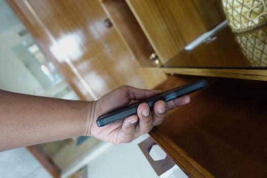 hand pick a smart phone from a drawer photo