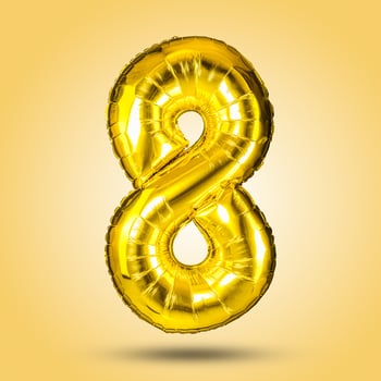 A shiny, golden number eight balloon, isolated on a bright yellow background. Perfect for birthday celebrations, anniversaries, and festive occasions, adding a touch of fun to any party. photo