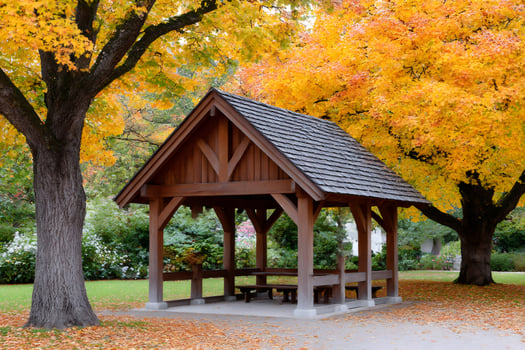 Wooden gazebo under colorful autumn trees in a park photo