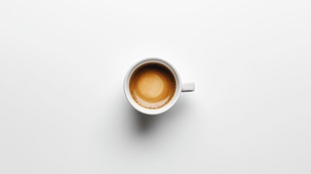 High-angle view of a white coffee cup filled with espresso photo