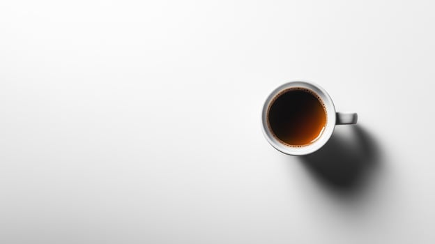 High-angle view of a coffee cup on a plain white surface photo