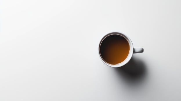 A coffee cup, filled with dark liquid photo