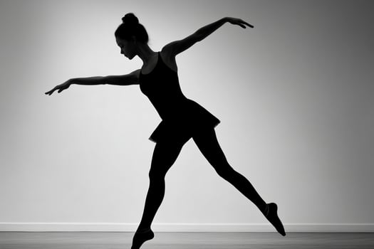 A silhouette of a young ballerina in a black dress photo