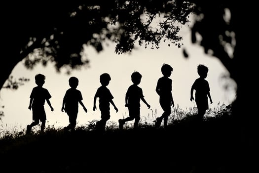 Silhouette of children walking on a hill photo