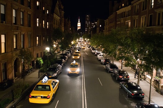 A street with cars and taxis at night photo