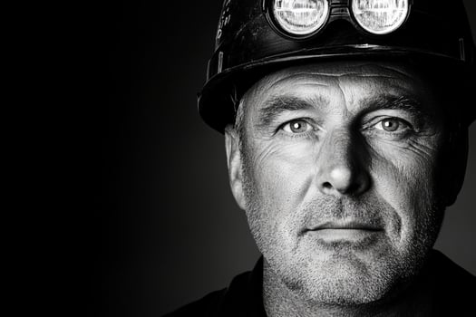 A man in a hard hat and black shirt photo