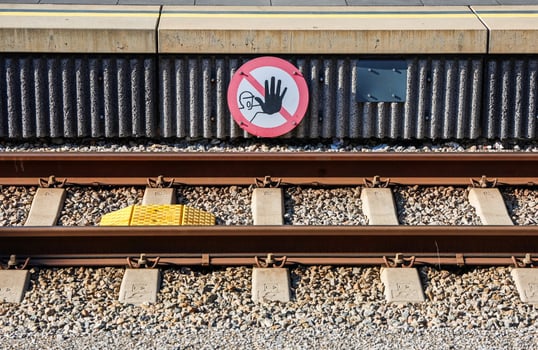 Do not cross, railway tracks and warning sign at station platform photo