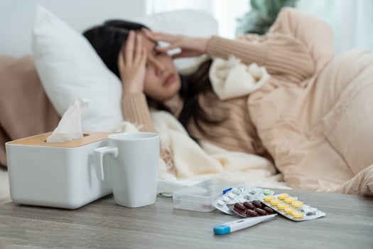Young Asian woman having high fever while checking body temperature, female sneezing and runny nose with seasonal influenza, taking medicine, virus, coronavirus, illness, respiratory,. photo
