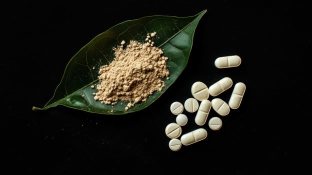 A leaf and some pills on a black background photo