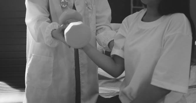 A woman in a white shirt is holding a white object photo