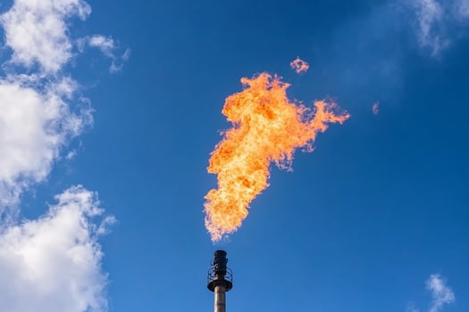 A gas flare is seen in the sky photo