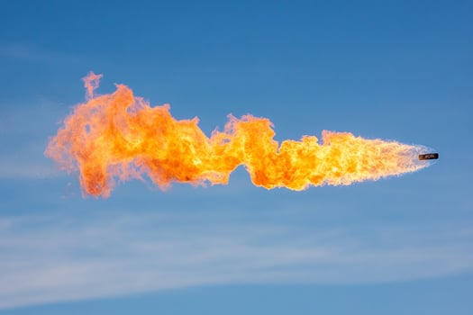 A large orange flame is being blown out of a jet photo